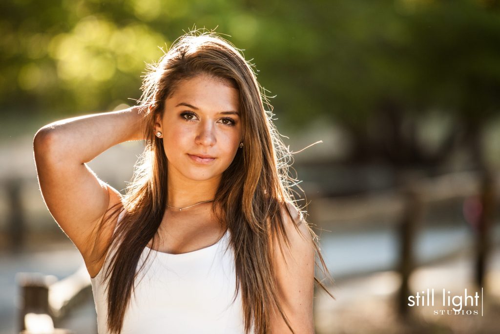Smiling high school senior girl outdoors in golden light, Still Light Studios
